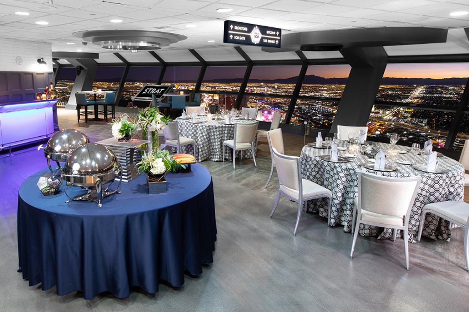 The STRAT Tower Level 108 tables set up with tablecloths with view of the Las Vegas Strip